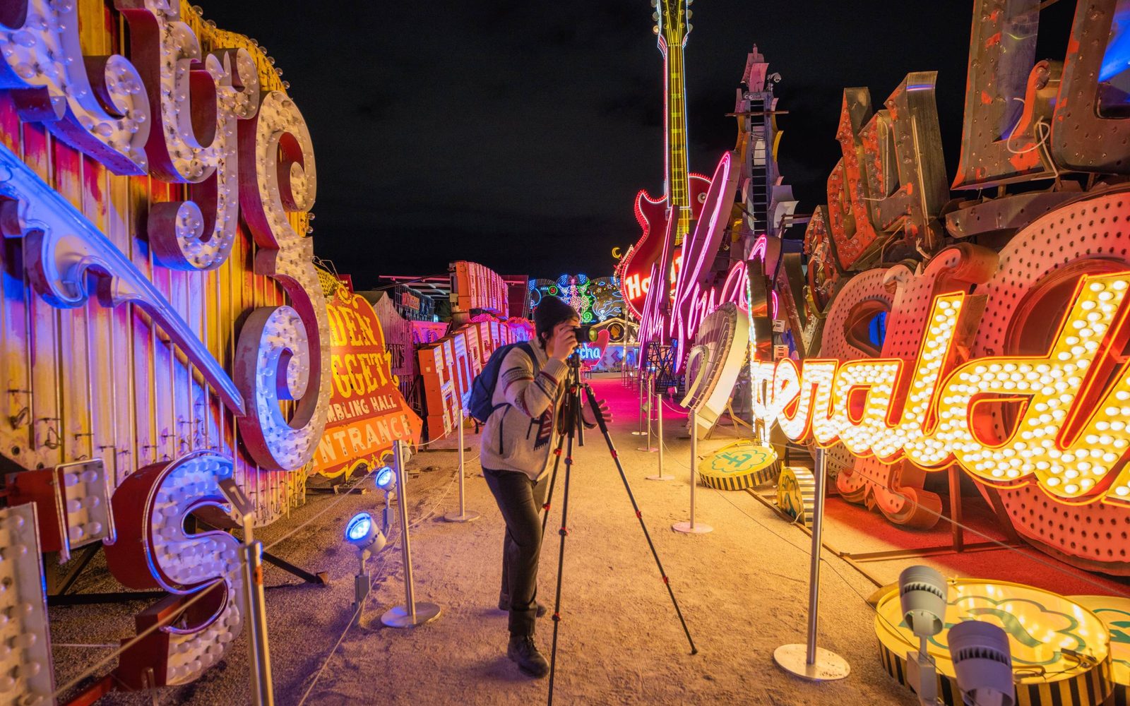 Visitor taking a picture of the Fitzgerald sign at The Neon Museum's Neon Boneyard.