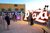 Photo Policy Masthead A museum guide takes the picture of a couple in front of the Plaza sign at The Neon Museum's Neon Boneyard.