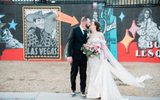 A couple kissing, standing outside of The Neon Museum's North Gallery.