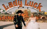 A couple walking in front of the Lady Luck sign in The Neon Museum's North Gallery.