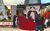 Photo of a woman in large red dress and photographer Photo of a woman in large red dress and photographer