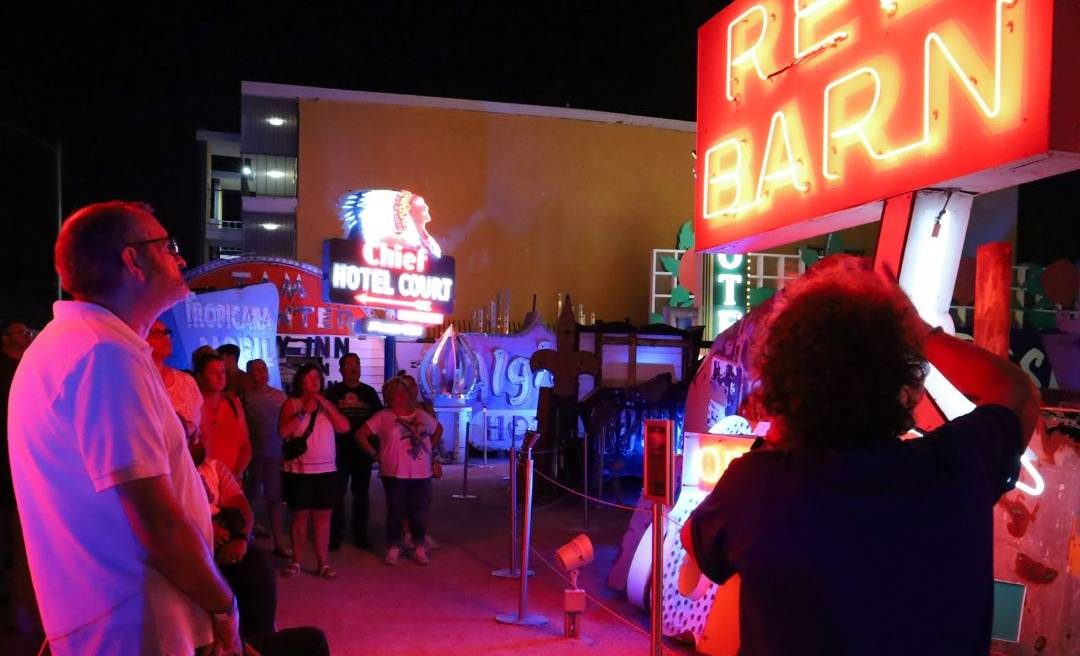 Visitors getting a tour at the Neon Boneyard