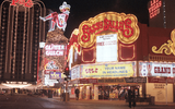 Nighttime image of Fremont Street including Sassy Sally’s Saloon, David Sapadin Photograph Collection, The Neon Museum, 1984