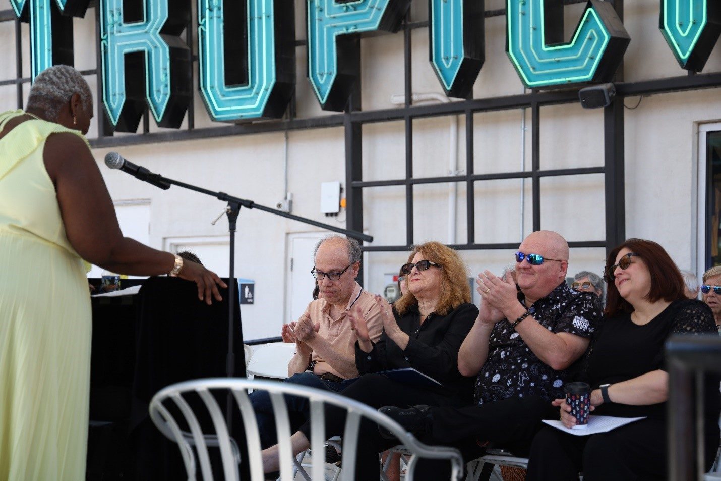 Participants and audience members applaud Phyllis Hargrove as she concludes her story reading at the final event.
