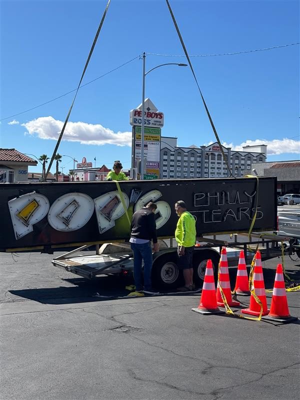 An image of Pride of Philly sign being craned to a flatbed