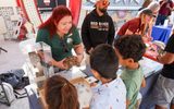 Community partner shows desert wildlife to children during STEAM Family Fest.