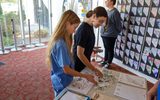 STEAM Family Fest attendees perouse stickers