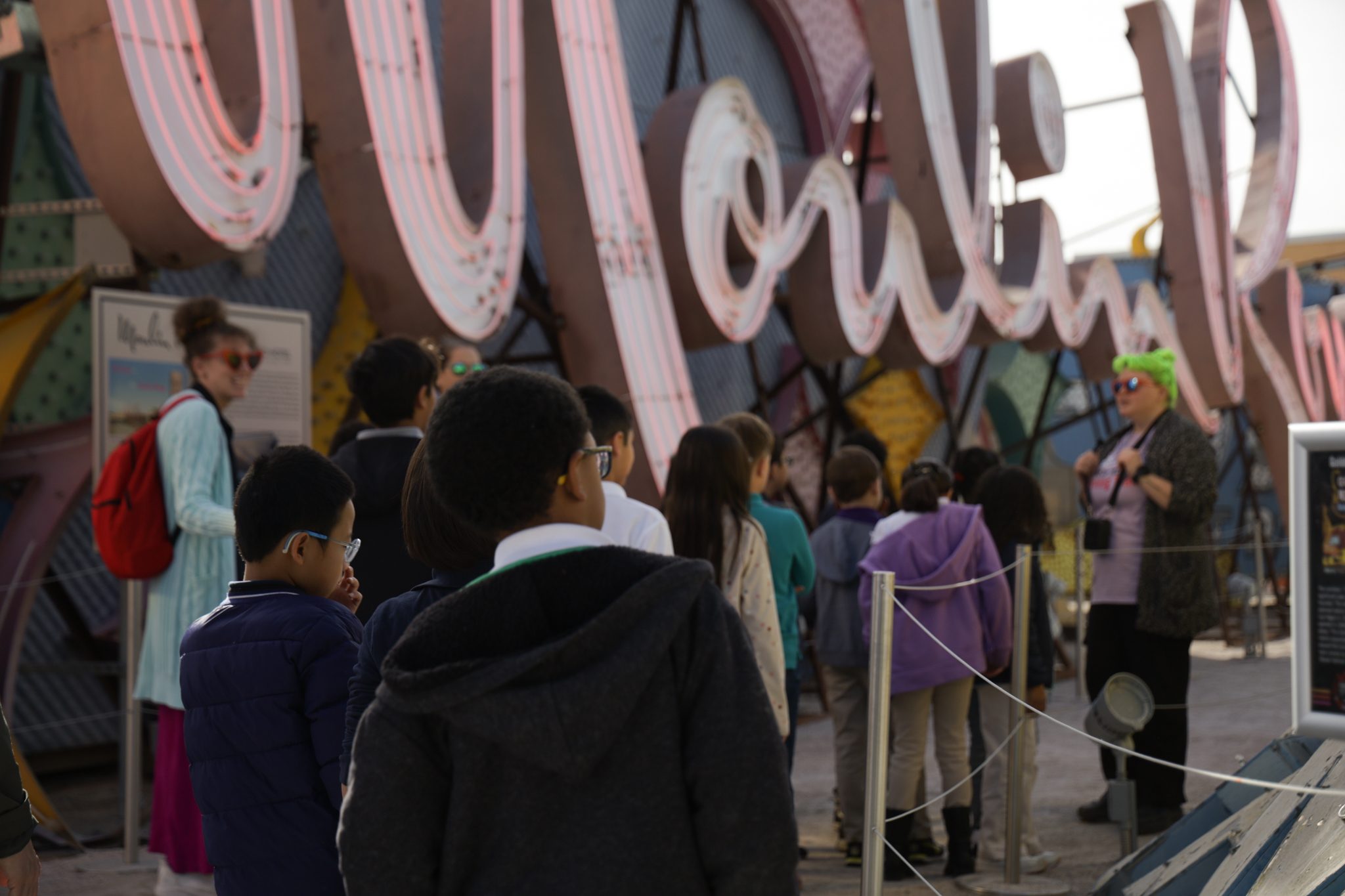 Children in a field trip taking a tour at the Neon Boneyard.