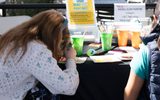 Children paint with neon paint during STEAM Family Fest.