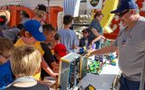 Children seeing plastic bricks displays during STEAM Family Fest